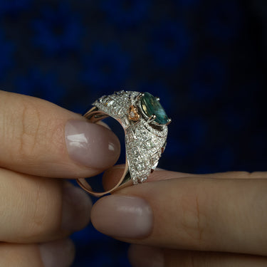 Close-up of a 1.16ct natural alexandrite ring in 18k white gold with intricate diamond detailing and yellow gold heart accents.